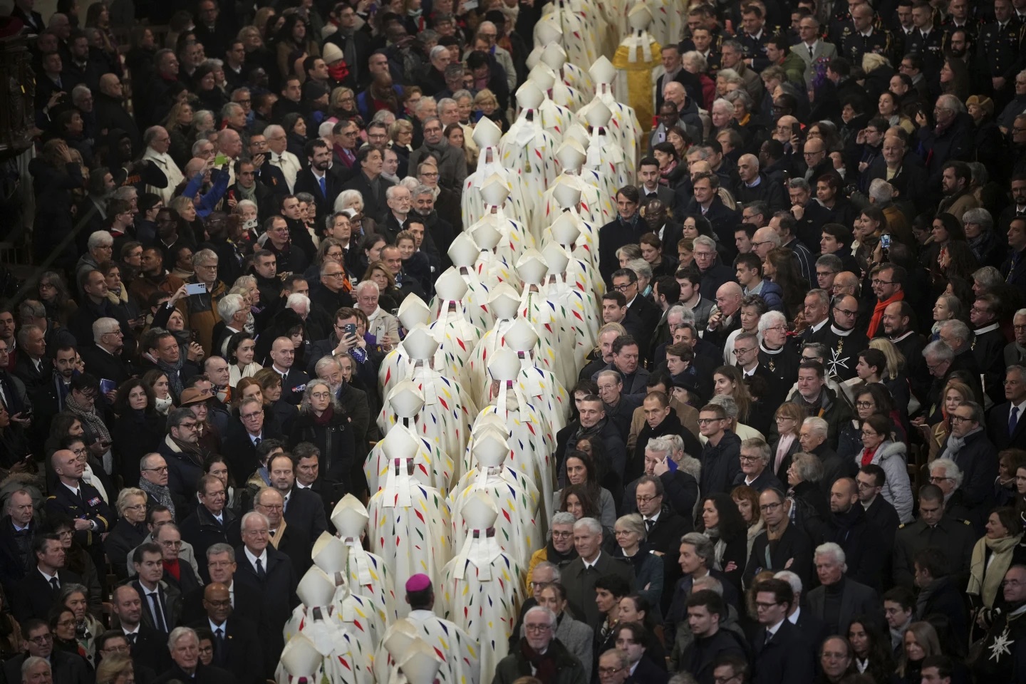 Guest watch clergy members leaving the inaugural mass at Notre Dame Cathedral